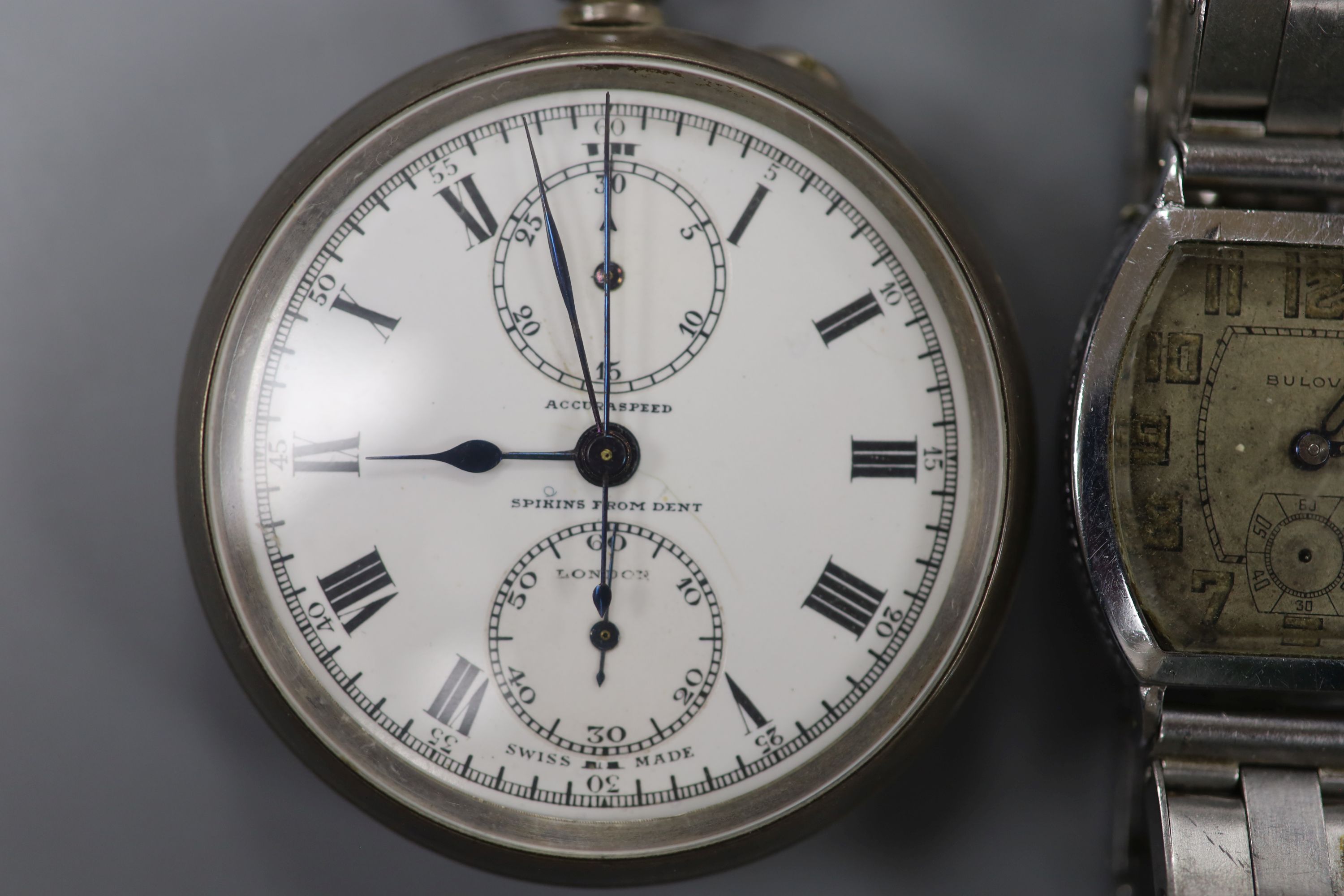 A 1930s Bulova plated wristwatch on later stainless steel bracelet and a Spikins from Dent Accuraspeed silver pocket chronograph (2)